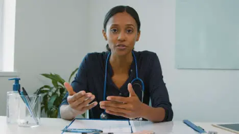 Young Female Doctor Talking to Webcam