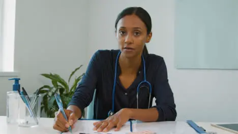 Young Female Doctor Listening During Webcam Chat