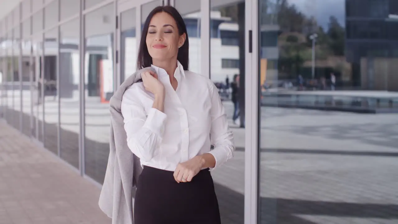 Business woman with jacket over shoulder