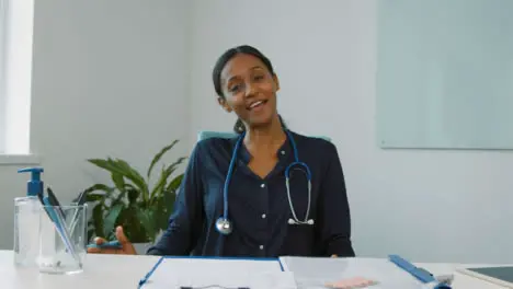 Young Female Doctor Leading Video Meeting Briefing