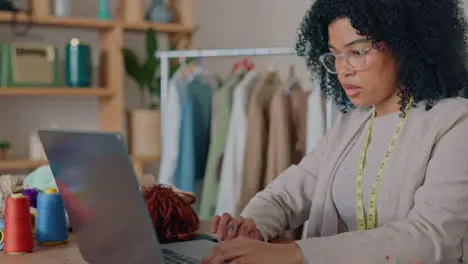 Black woman laptop or fashion designer in retail