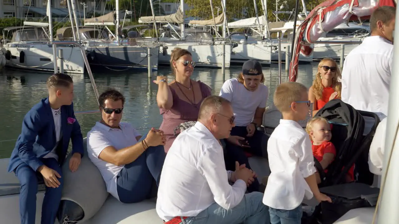 People relax in the back of a Catamaran sail boat in the Marina of Montpellier France