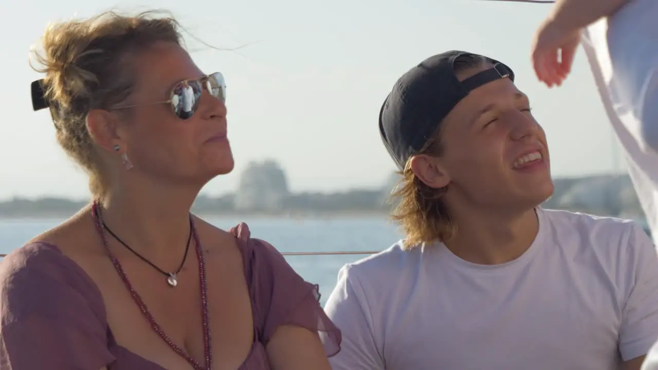 Mother and son enjoying a sunny day on a sailing boat