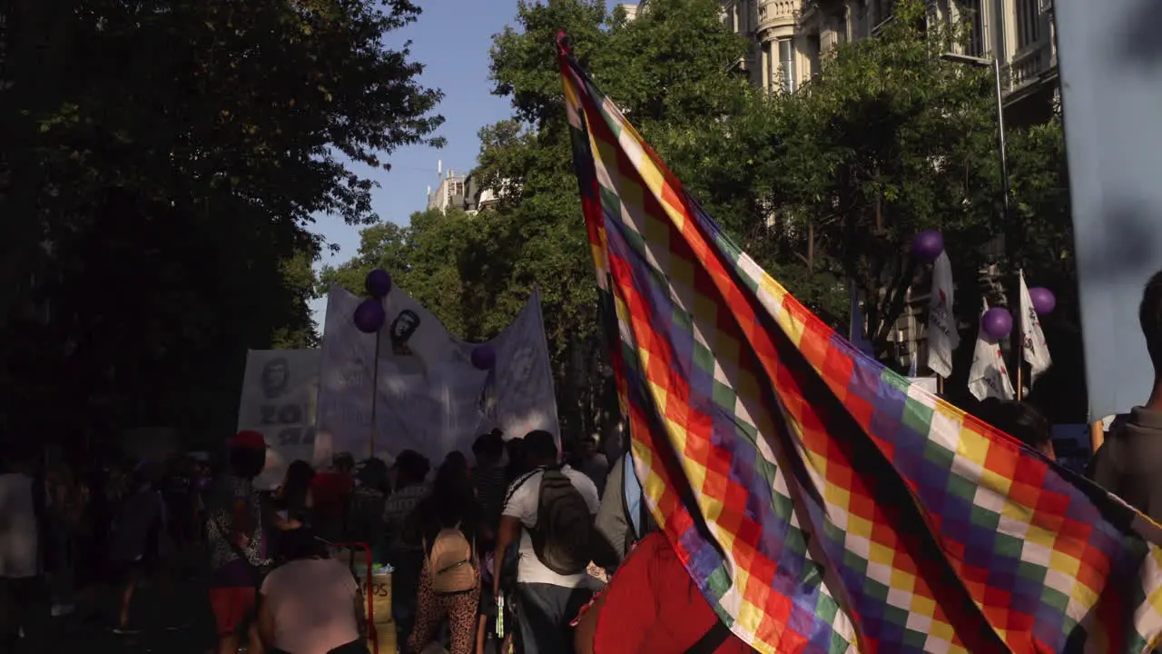 political colourful flag waves at public street gathering representing human rights issues for native people