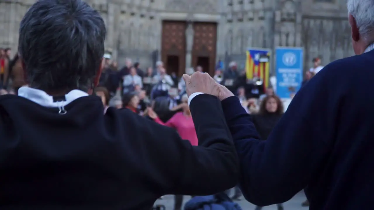 Medium Focus Shot Senior People Holding hands and dancing national dance Sardana at Plaza nova Barcelona Spain