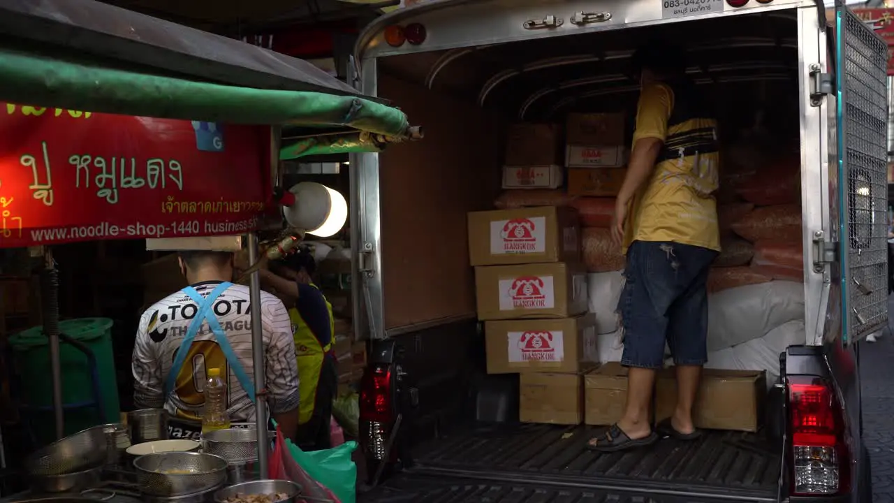 Scene of workers loading goods onto the truck in Yaowarat Chinatown Bangkok Thailand