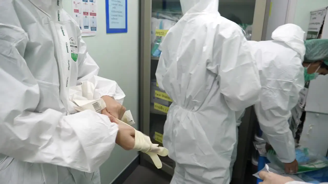 Medic Staffs Putting On PPE Suits Before Working Due To COVID-19 Epidemic