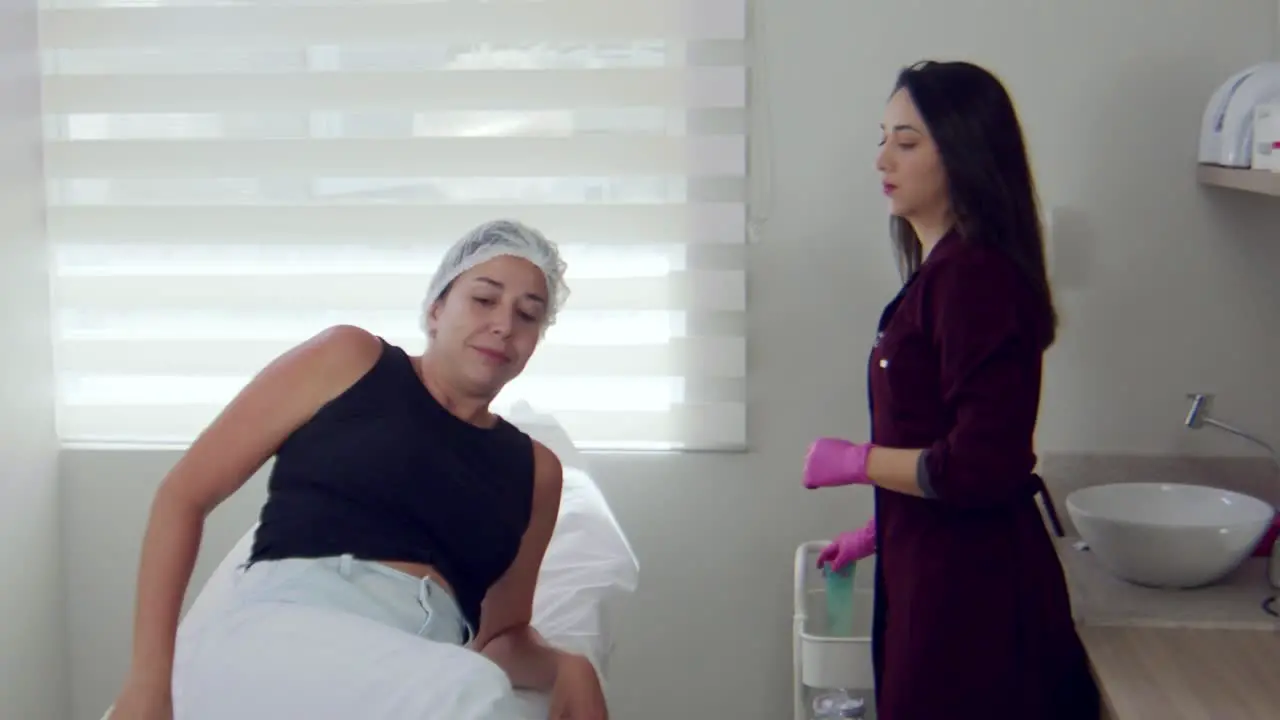 Latina woman in a doctor's office lying down on an examination table