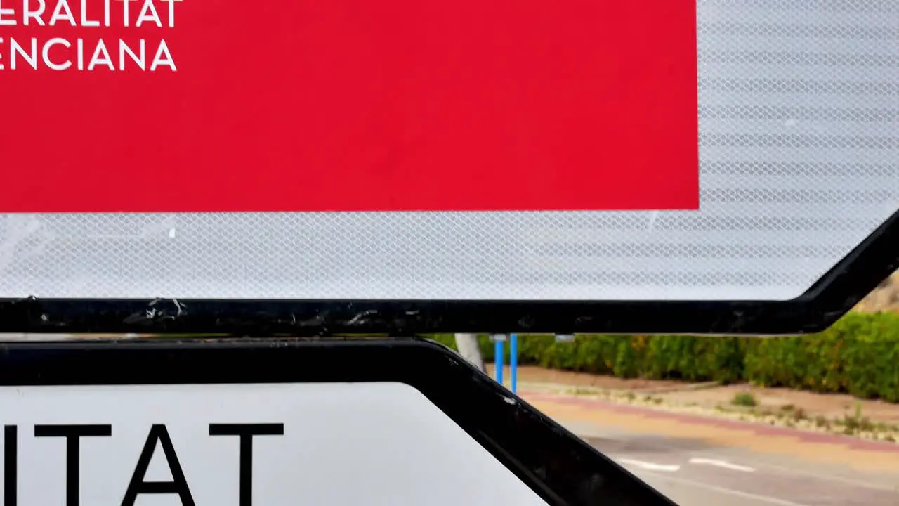 Slow pan between two signs pointing to a vaccination center in Alicante Spain