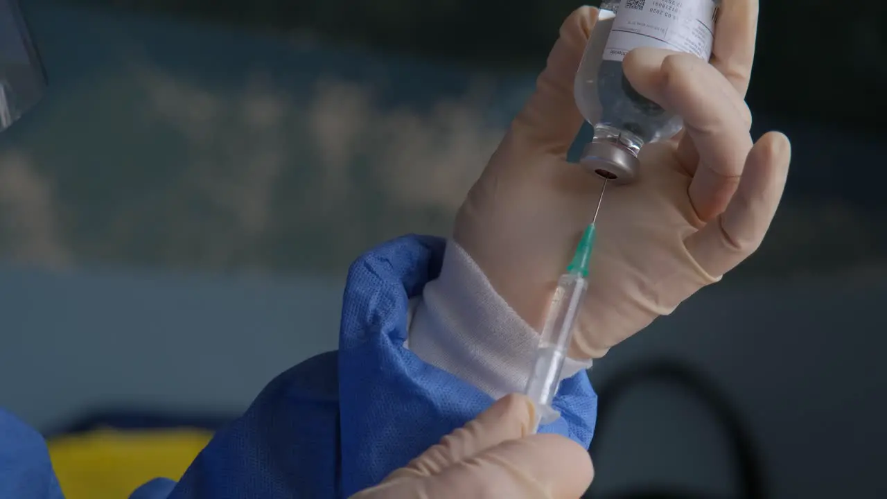 Close-up of a nurse measuring out a dose of the COVID-19 vaccine