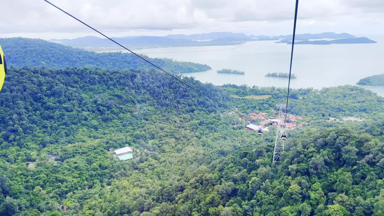 A shot of the cable cars moving along the rope over the mountain in Langkawi