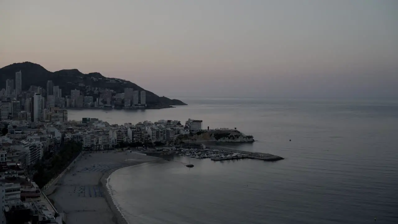 Mediterranean first light wide view Benidorm beach and coastline from above 4K