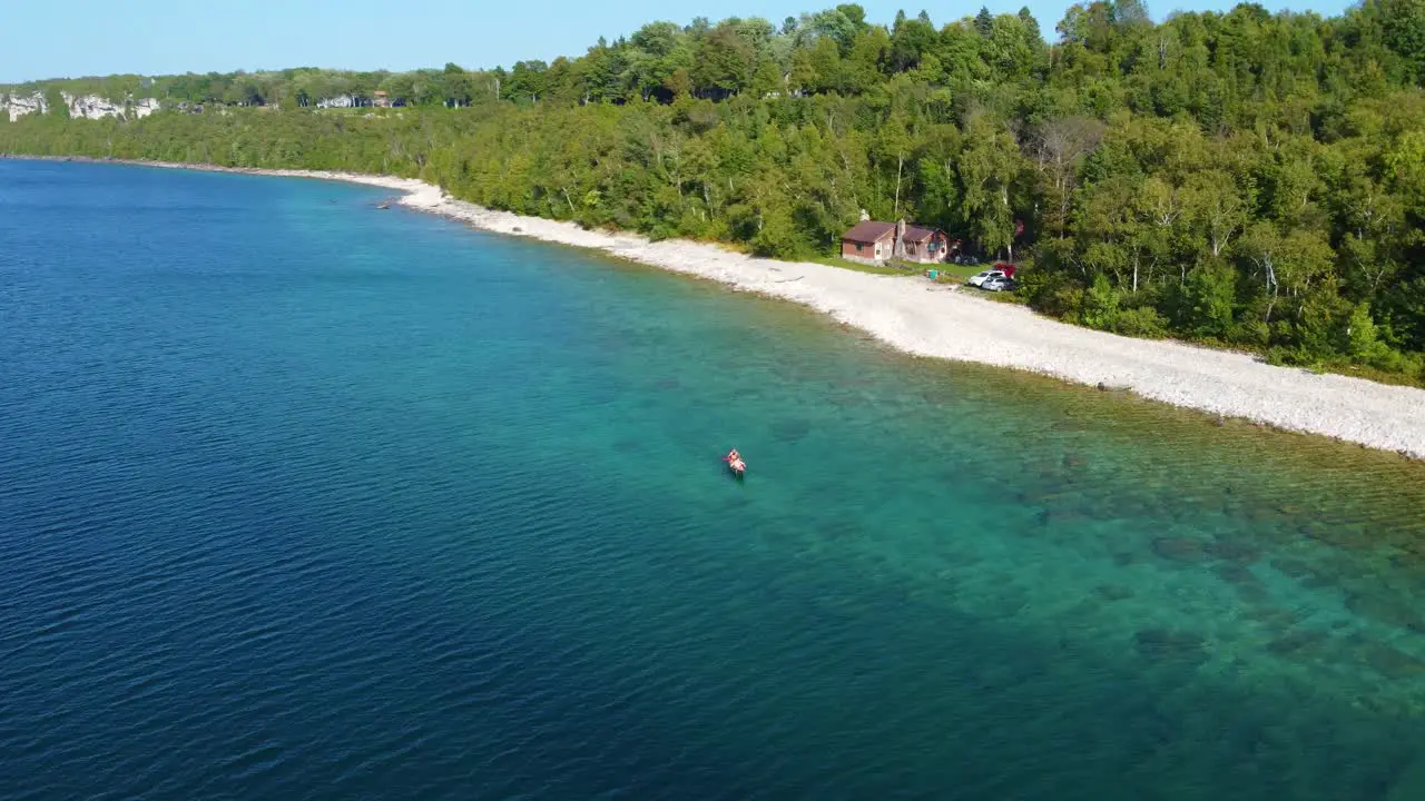 Aerial view of a waterfront home on Lake Huron as a kayaker paddles past