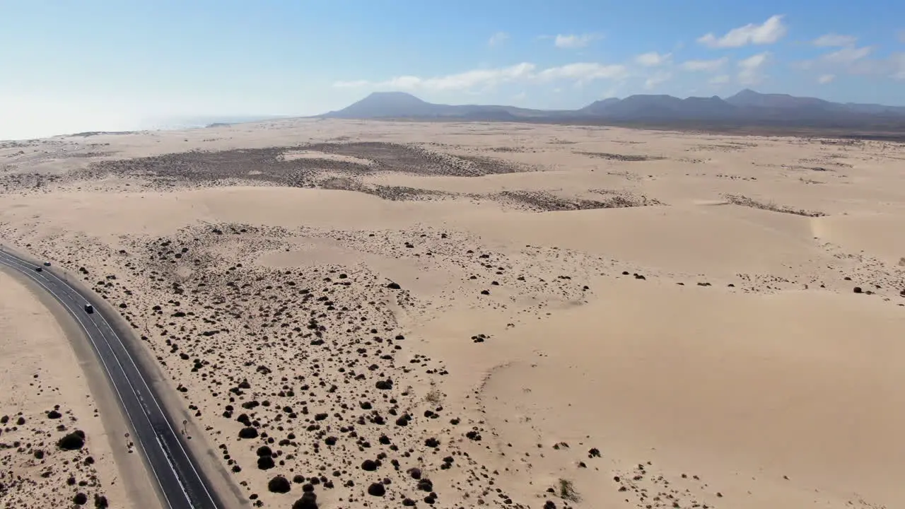 drone shot over road and infinite sand of corralejo beach Fuerteventura canary islands