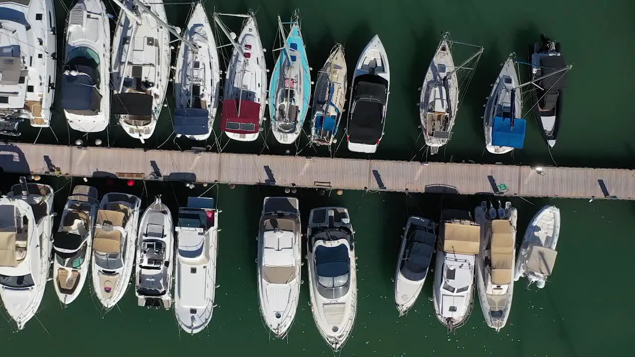 Sailing boats and luxury yachts moored at port aerial overhead view