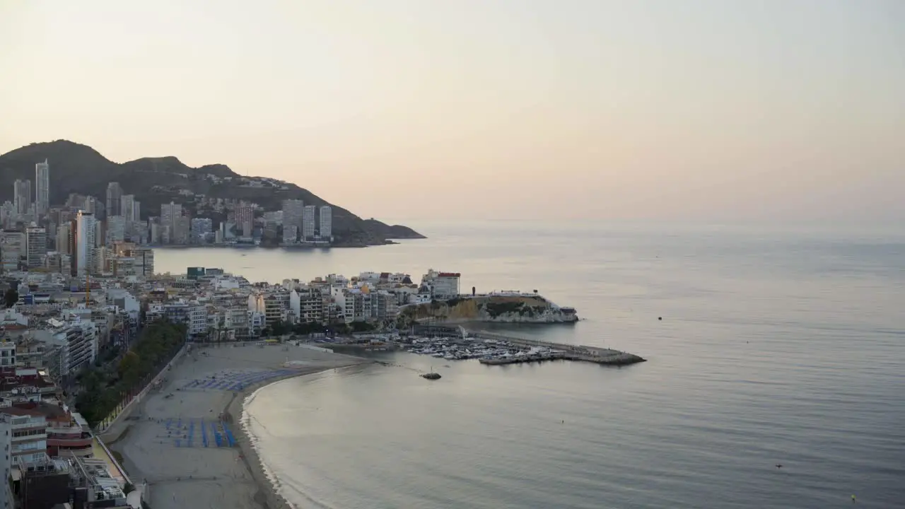 Mediterranean dawn wide view Benidorm beach and coastline from above 4K