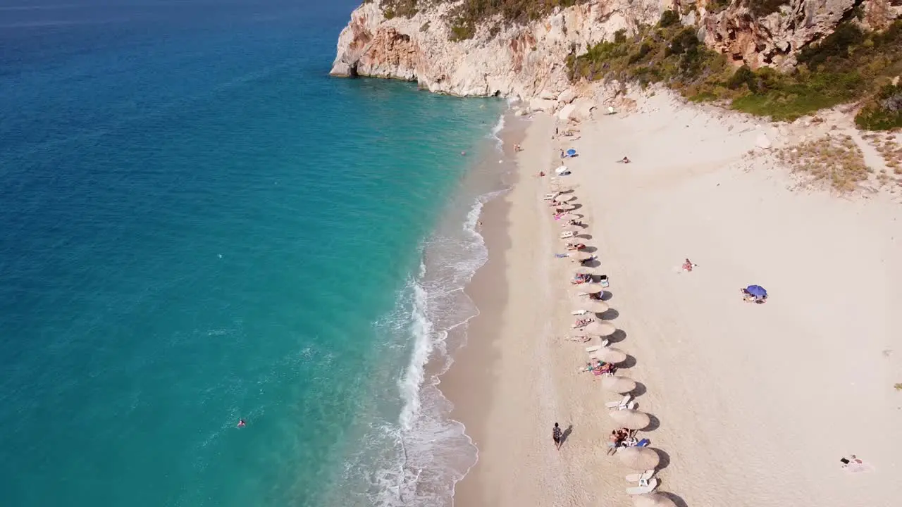 Tourist People Sunbathing at Milos Beach Lefkada Island Greece Aerial Reveal