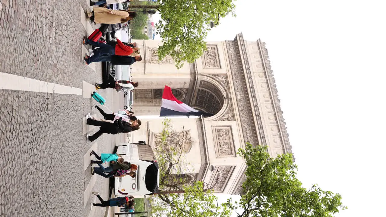 Street Crowds by Arc de Triomphe in Paris France Vertical