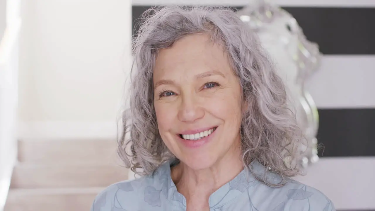 Portrait of happy senior caucasian woman in house