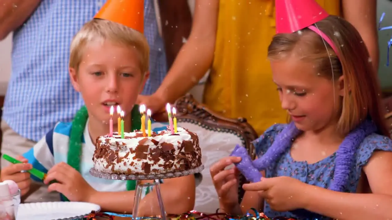 Animation of white spots over family having fun at birthday party