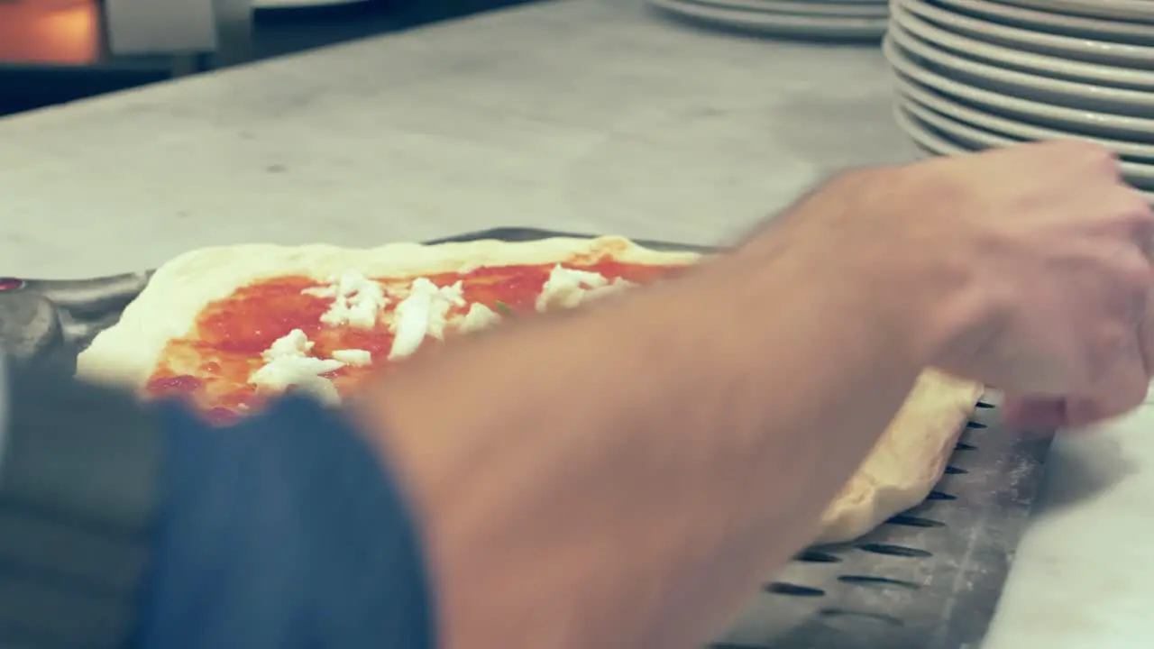 Cook Placing the Pizza in the Pizza Peel before putting it inside the oven