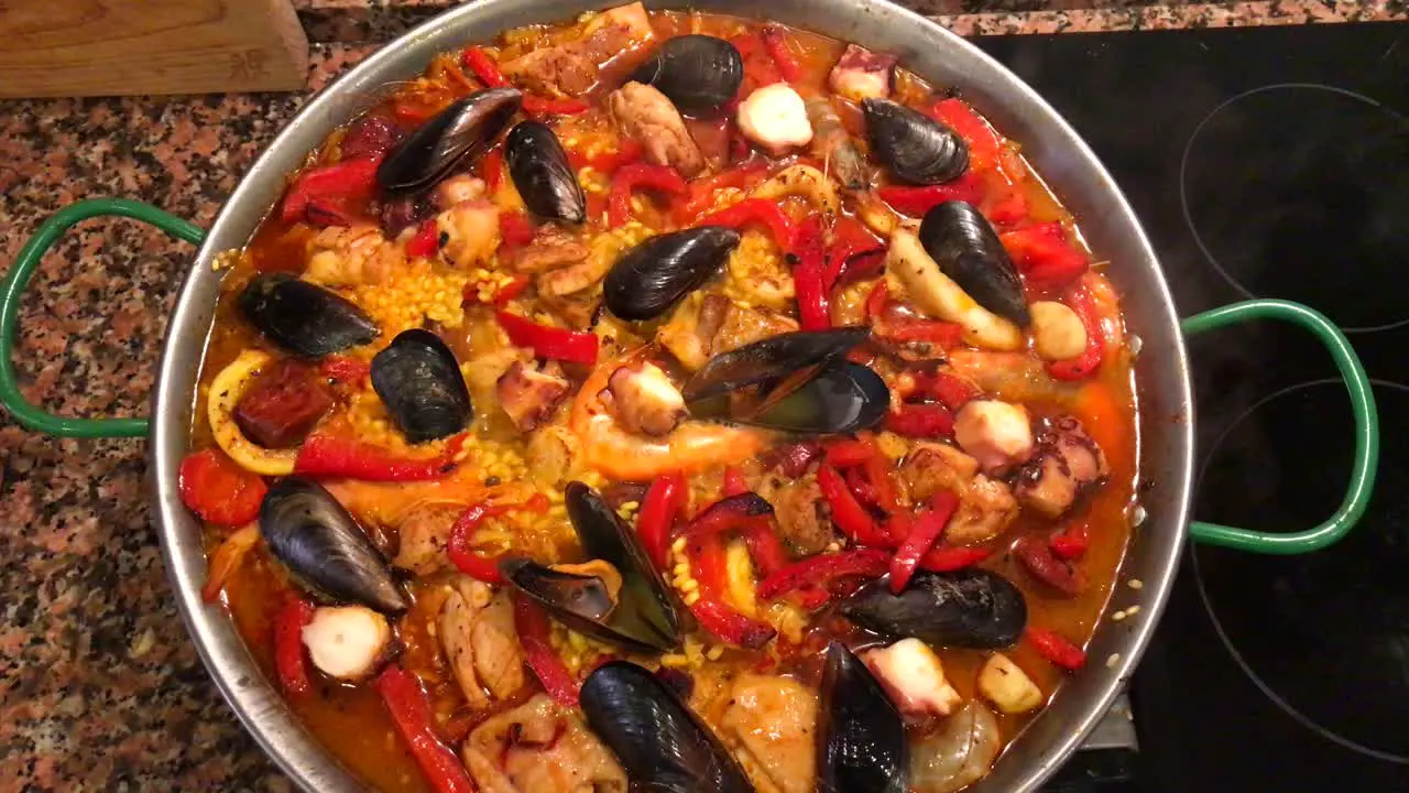 Cooking seafood traditional Spanish paella dish at home tasty Spanish dish with rice and seafood