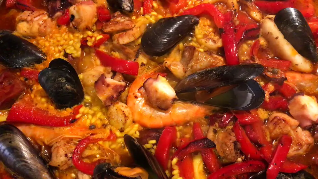 Close up of home made traditional Spanish paella cooking seafood dish with rice