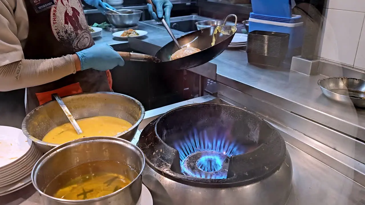 Stir frying and cooking the famous Thai dish Pad Thai in a restaurant in Bangkok Thailand