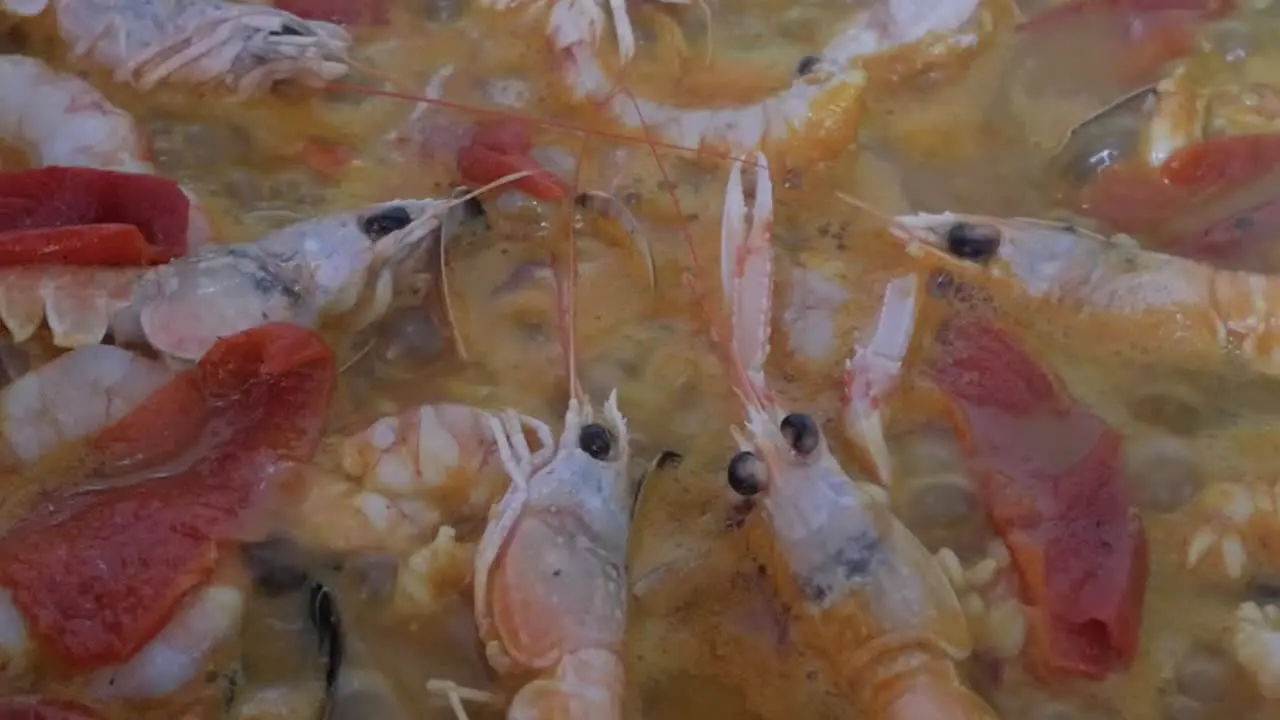 Close-up paella rice slow cooking