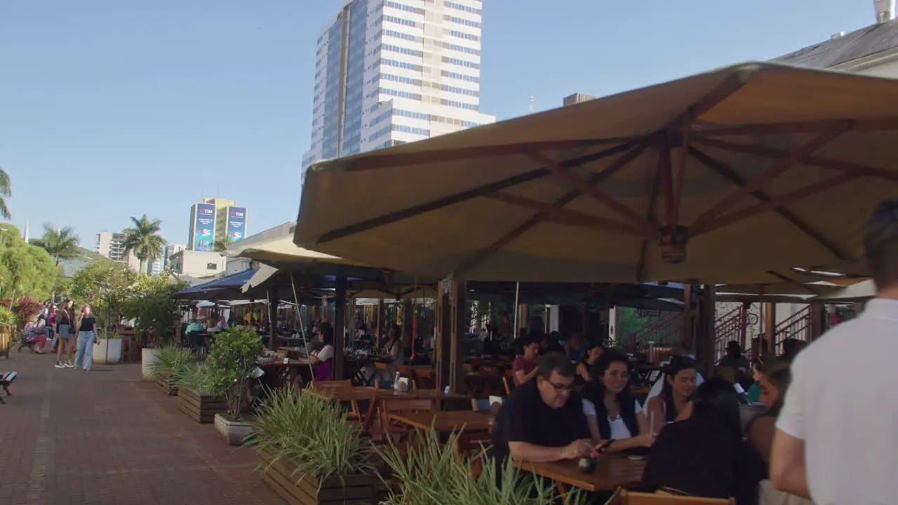 Waiters serving tables on outdoor terrace by the restaurant on food court