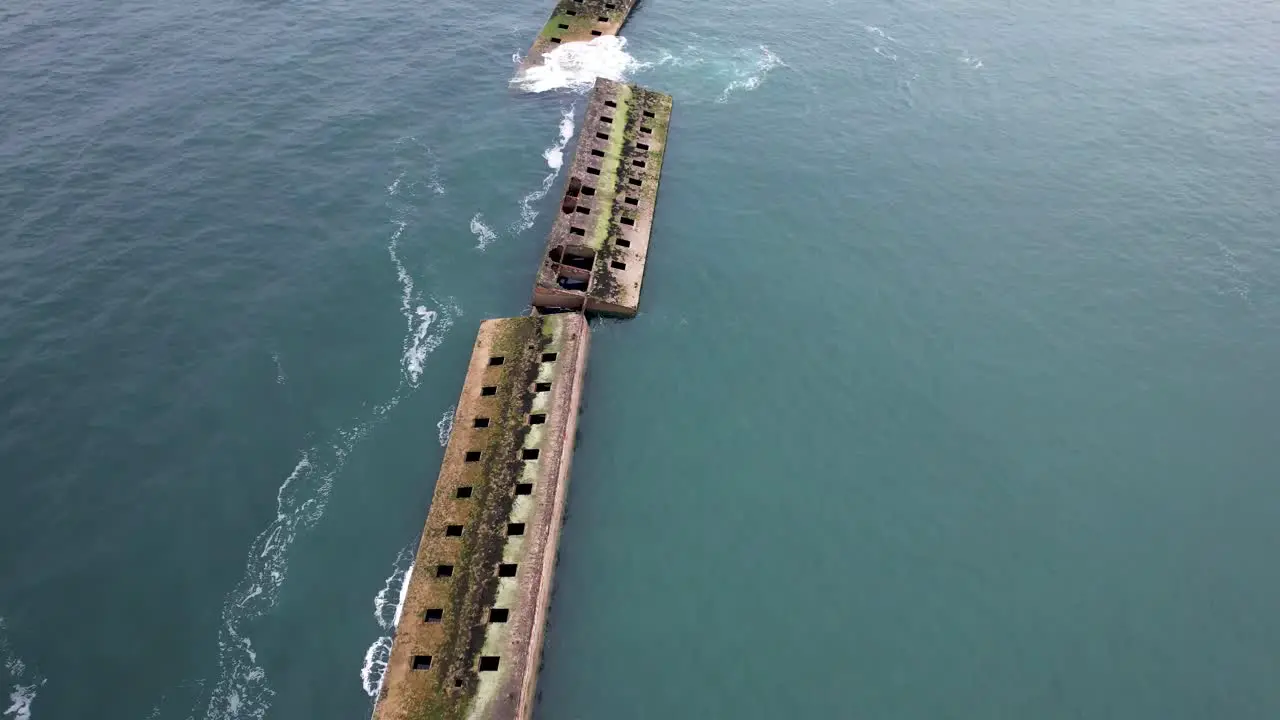 Aerial view of mulberry harbor ocean ruins from WW2 in Normandy France