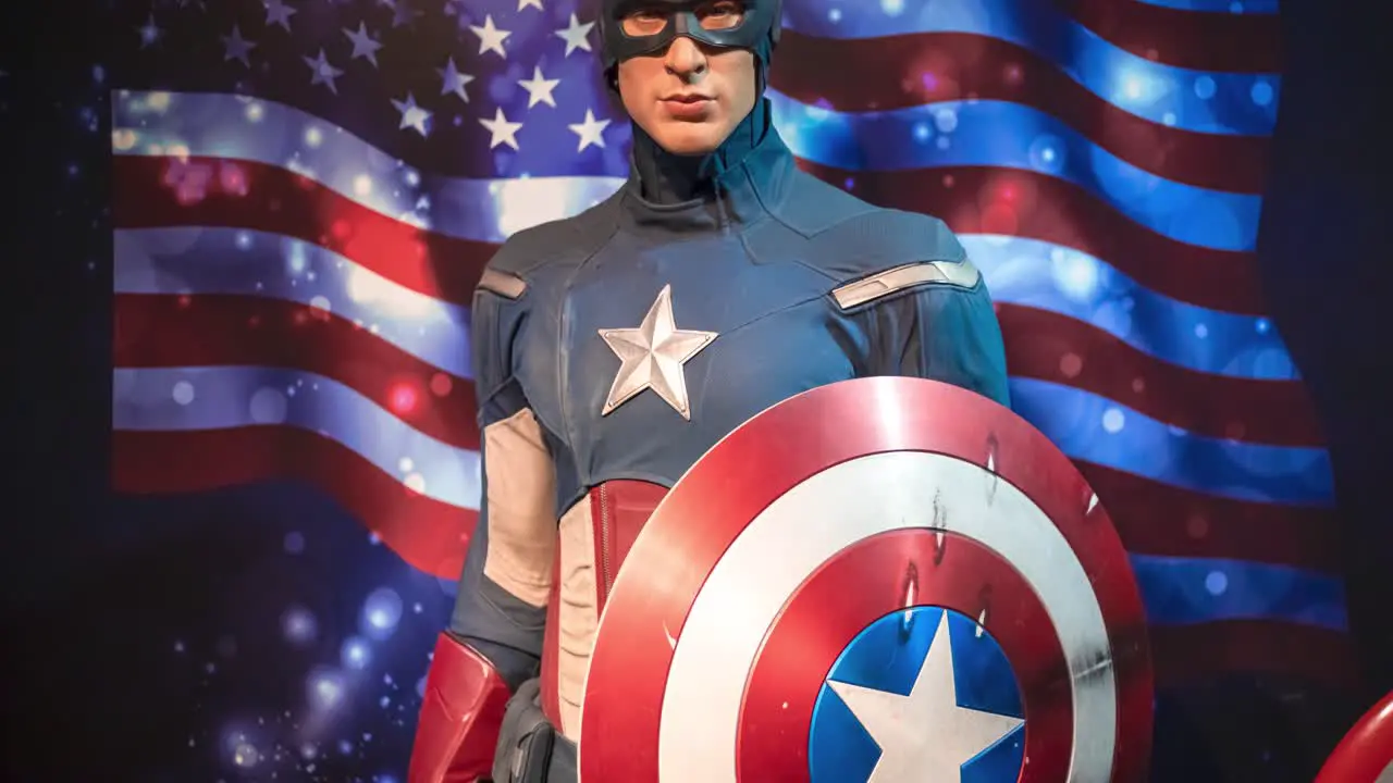 Wax Statue of Captain America against the American flag portrayed by Hollywood Actor Chris Evans at Madame Tussauds