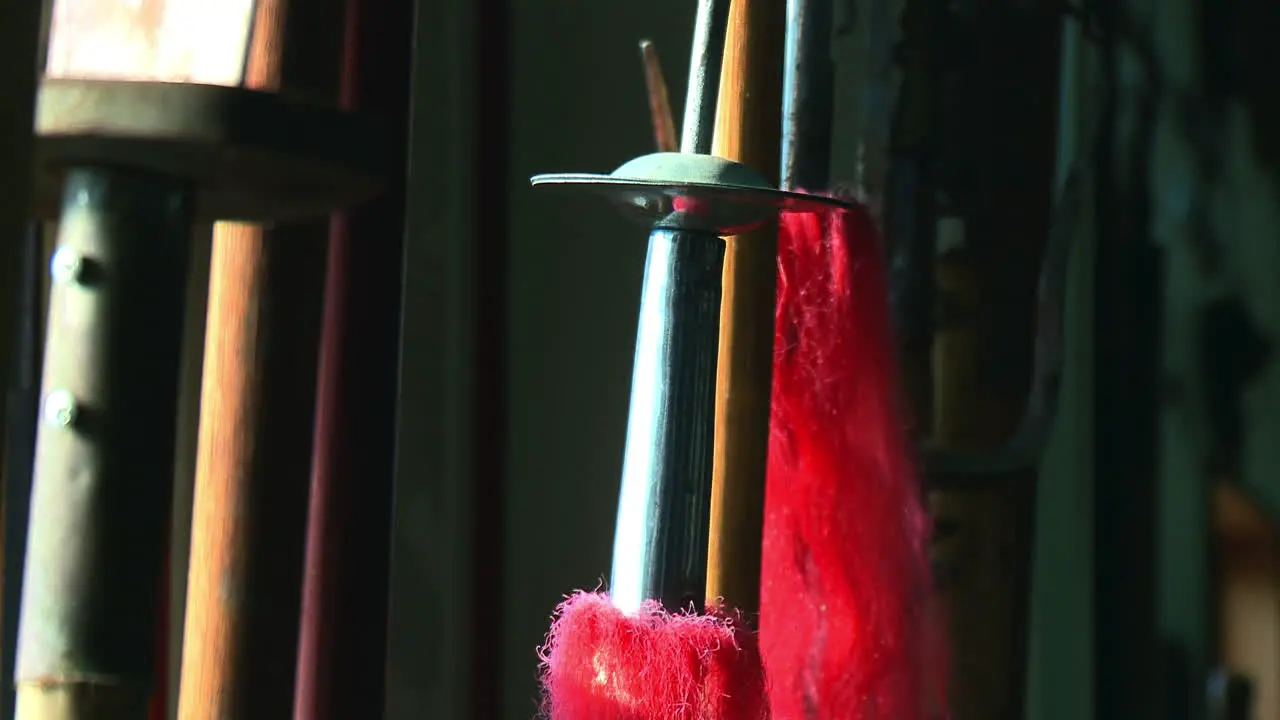 Red tassels on shaft of antique Chinese trident martial arts weapon