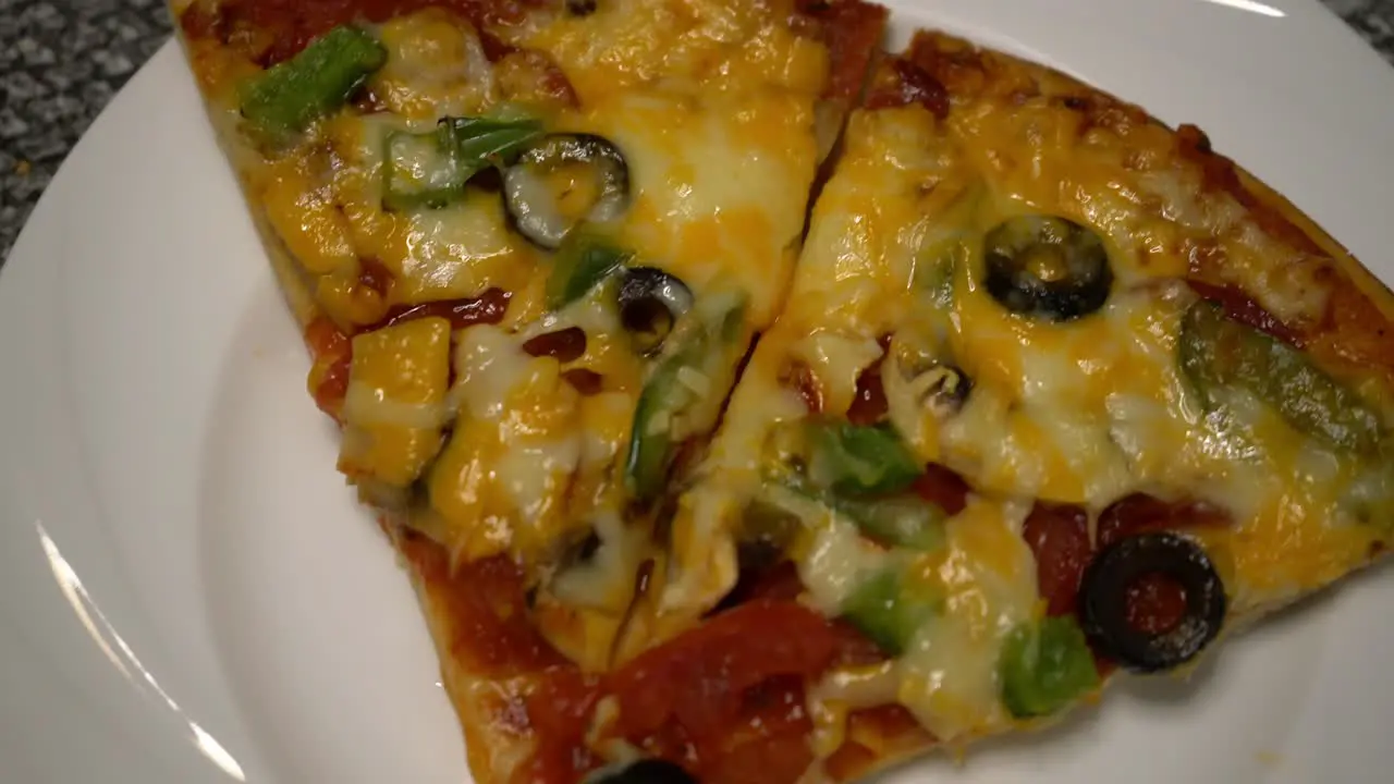 Homemade Pizza with two slices on plate at home