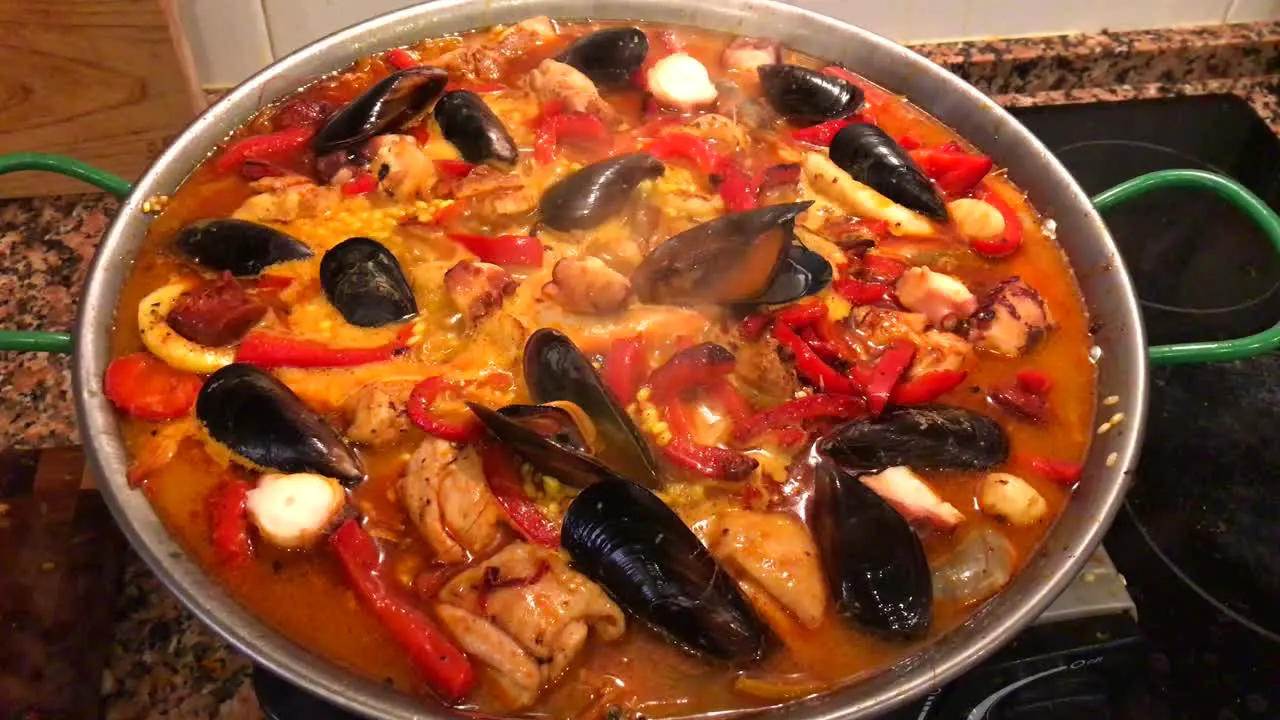 Cooking seafood Paella at home traditional Spanish paella with prawns mussels and fish