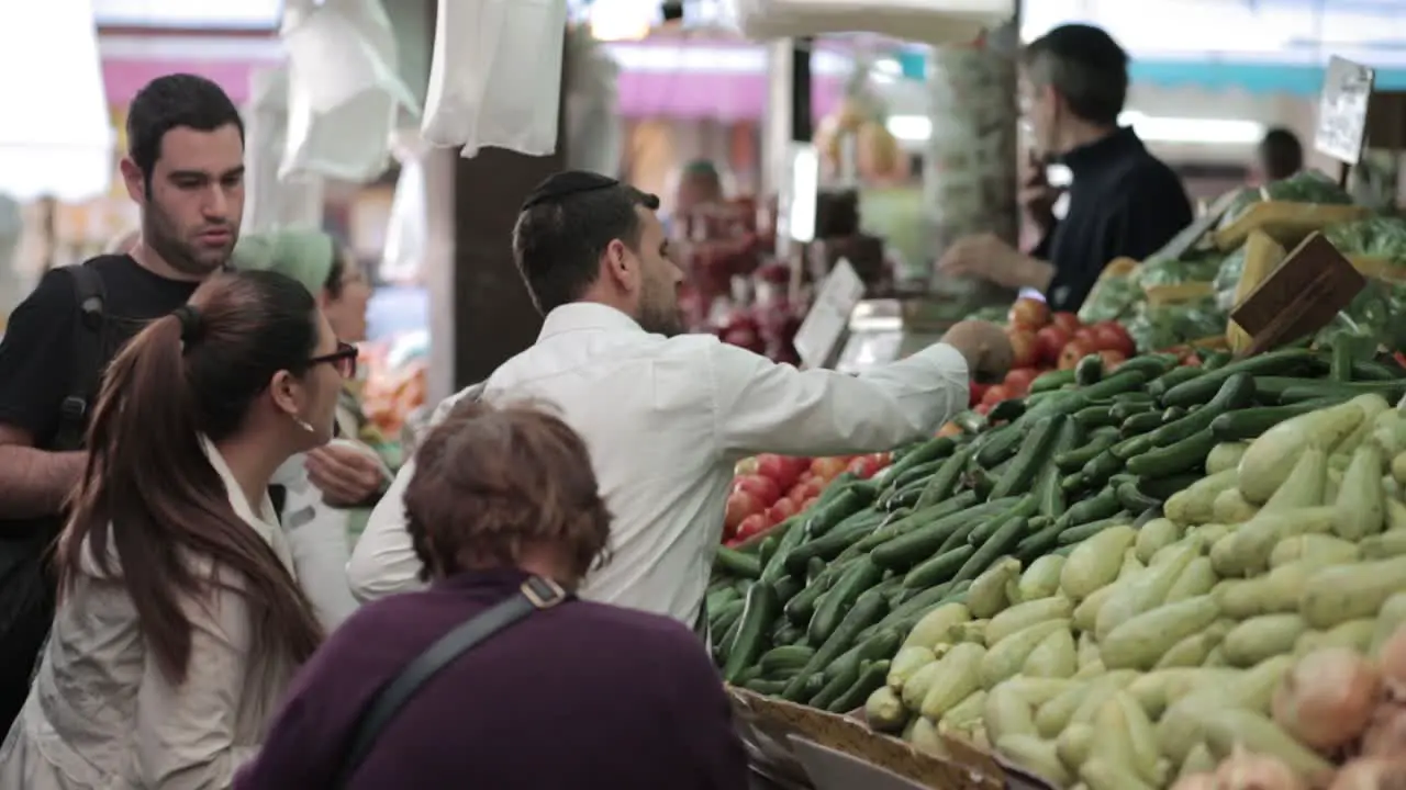 Mahane Yehuda market in Jerusalem man Buy Cucumbers