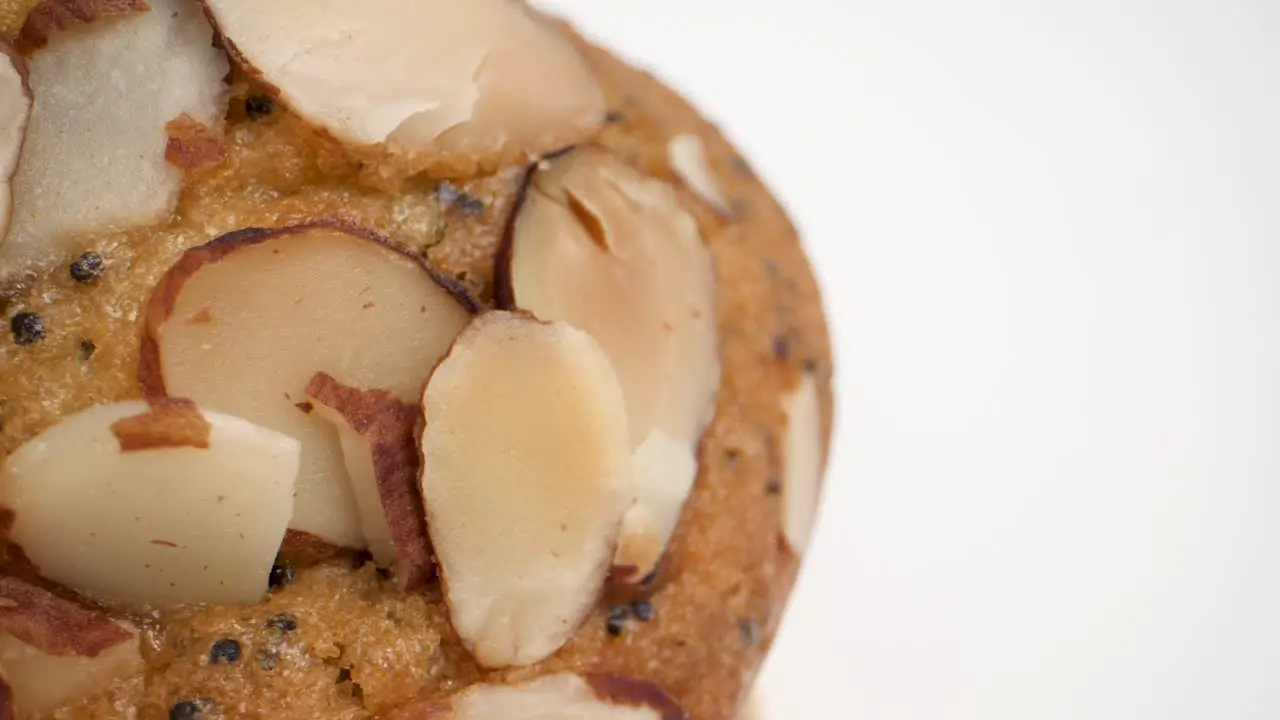 extreme closeup of lemon poppy seed muffin with almonds