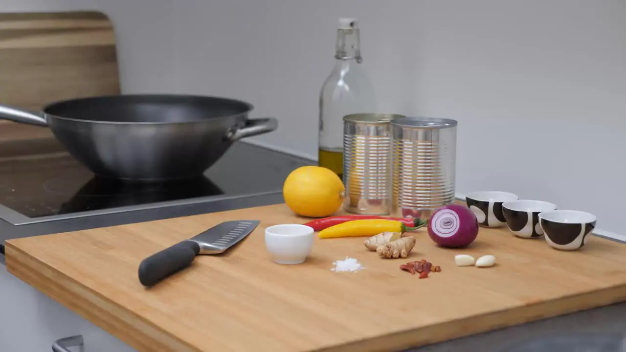 Male picks up knife and starts cooking Static camera