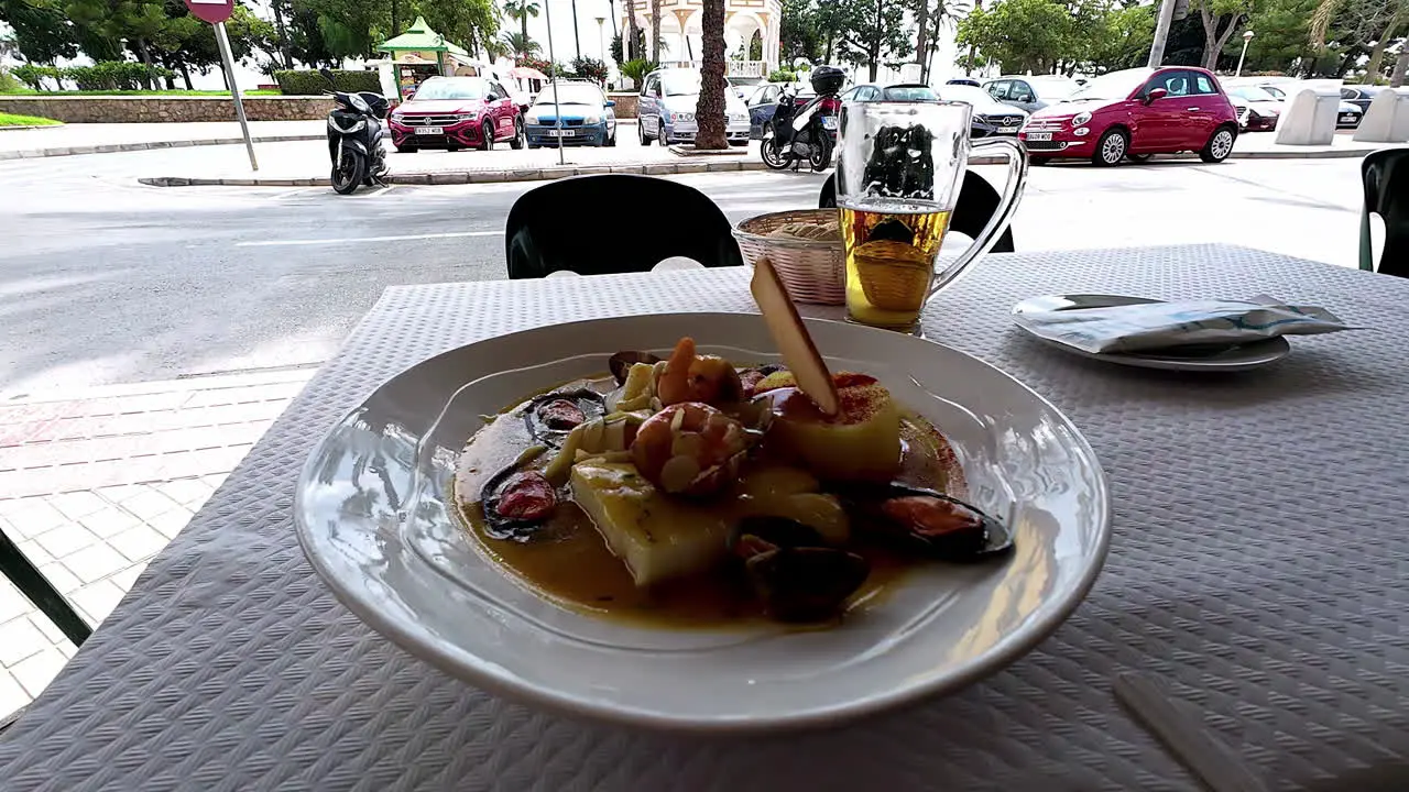 Close up shot of traditional seafood with mussels king prawns and squids on an outdoor restaurant table