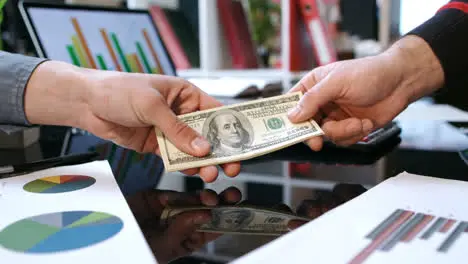 Transfer money cash from hand to hand Business handshake after money deal