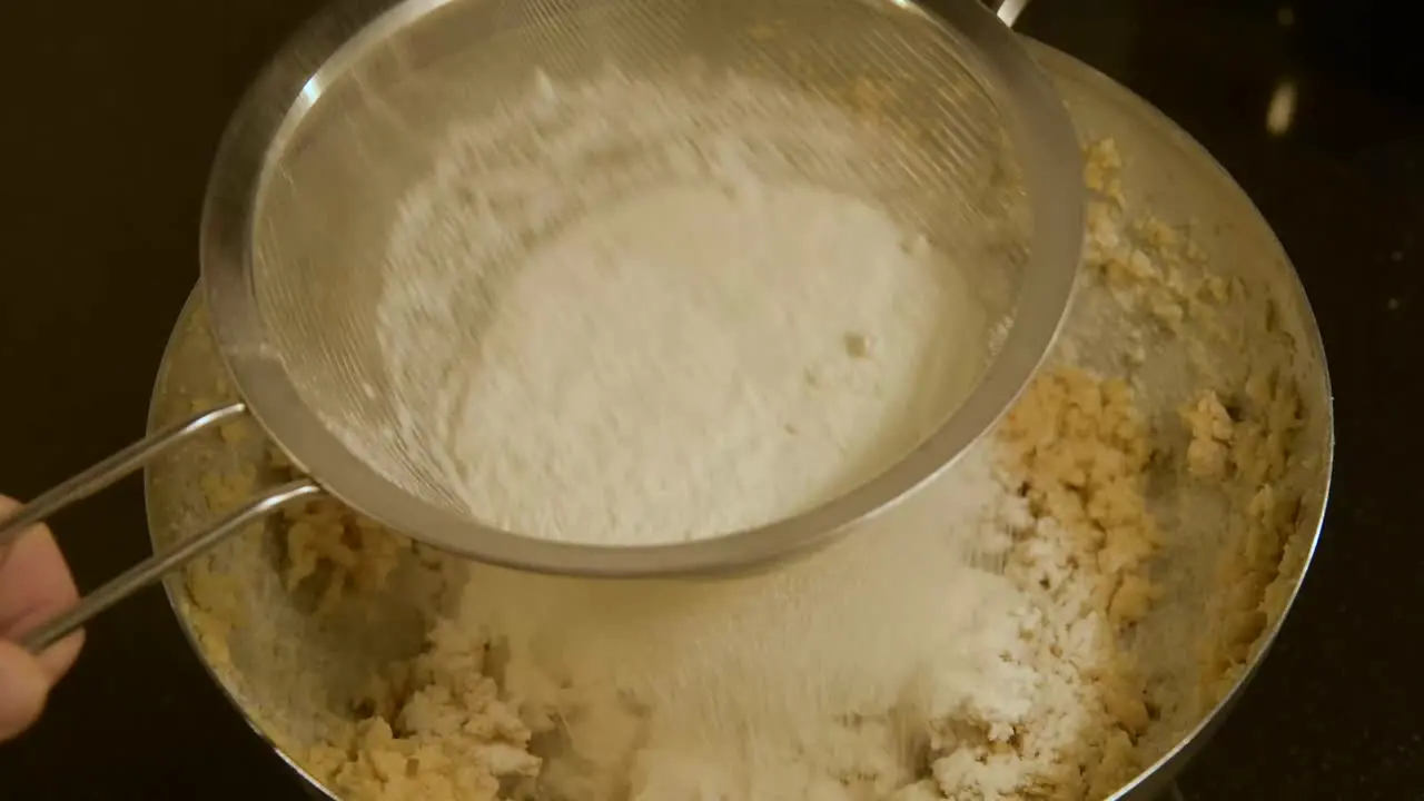 mixing flour through a sieve