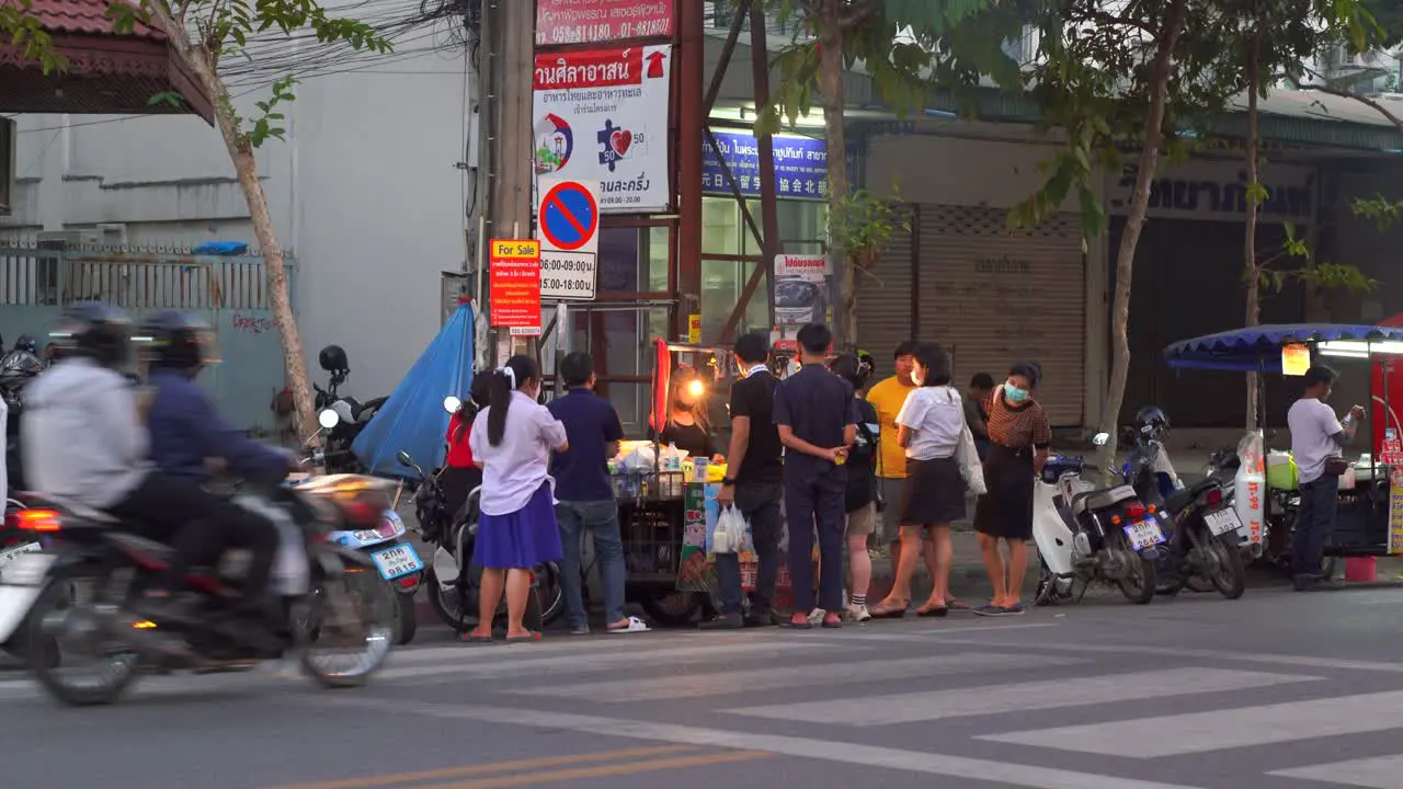 Local people gathered at typical street food stall in Chiang Mai Thailand