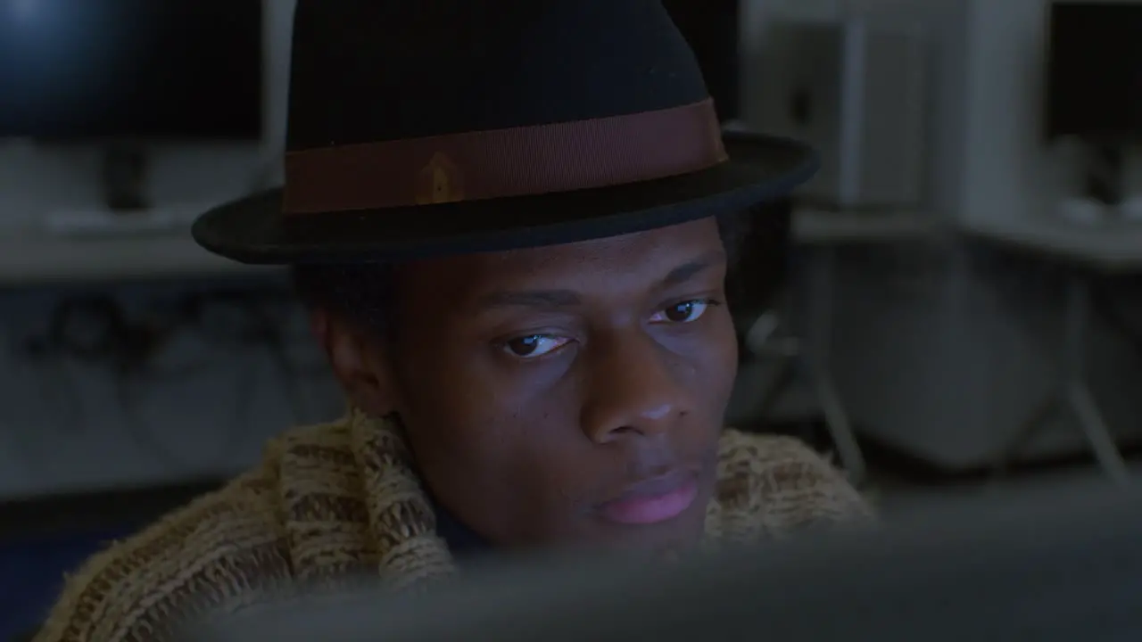 Developer with black fedora hat Working On Computer In Lab high angle