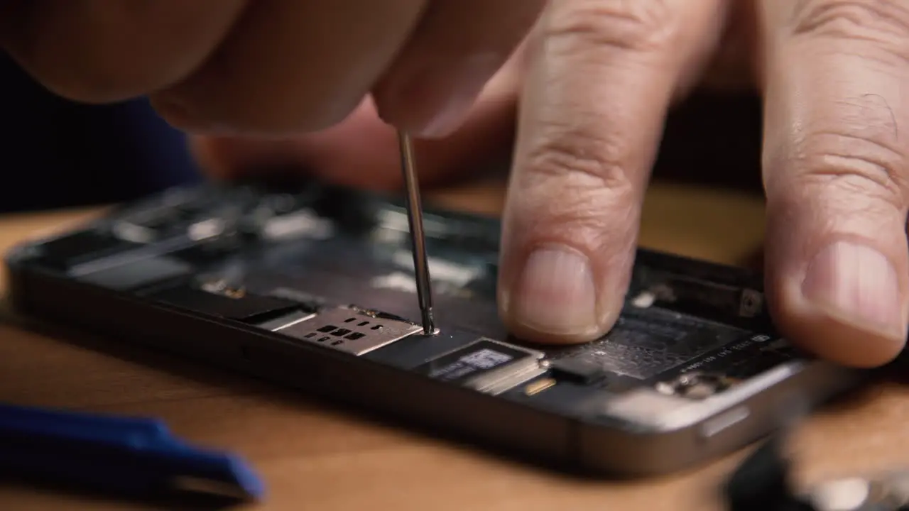 Phone being disassembled by an amateur technician