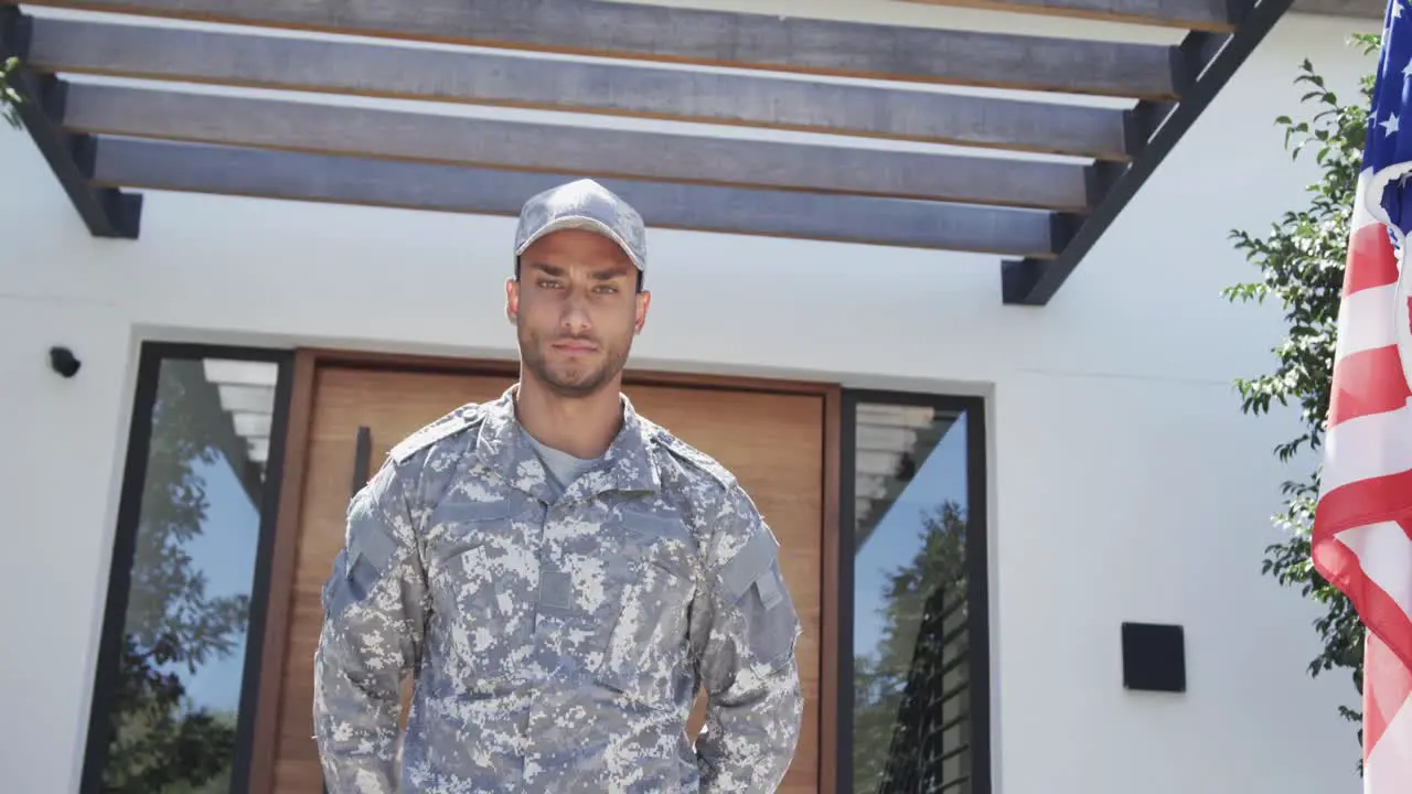 Portrait of biracial male soldier saluting outside the house unaltered copy space slow motion