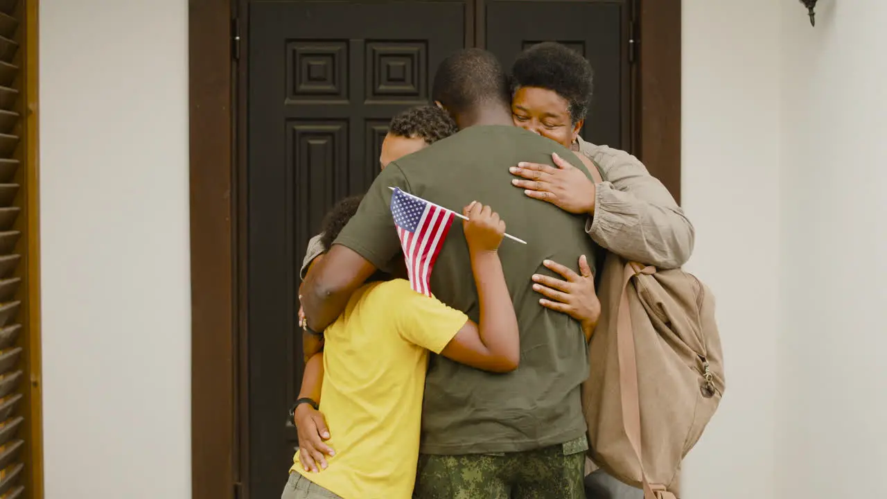 Male Soldier Hugging And Saying Goodbye To His Family Outside Home Before Going For Military Service