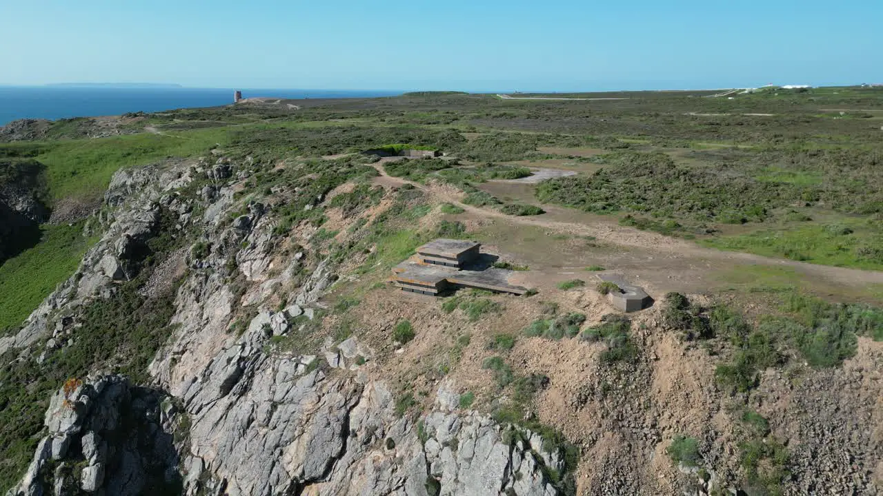 pull back drone aerial reverse reveal cliff top German bunkers Channel islands