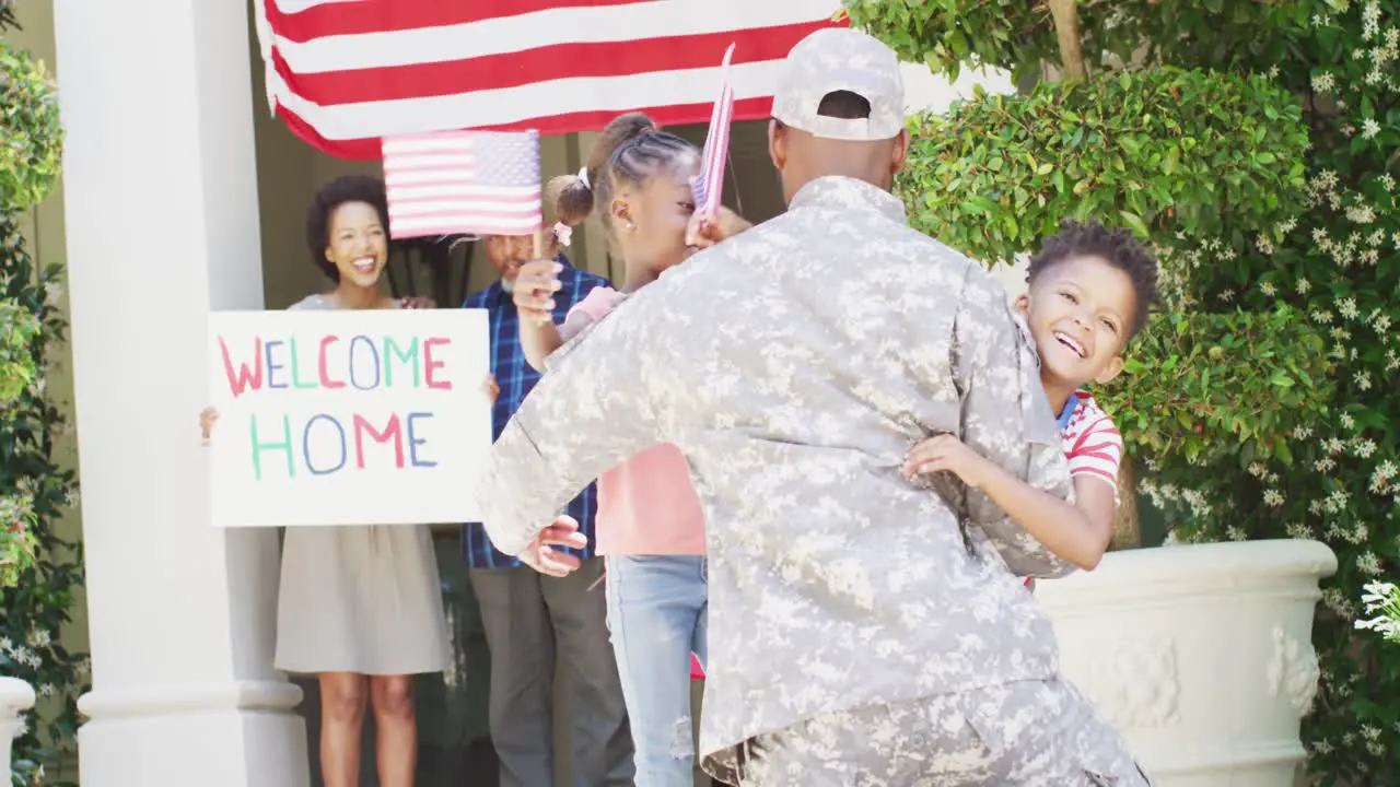 African american male soldier returning home greeted by happy children and family slow motion