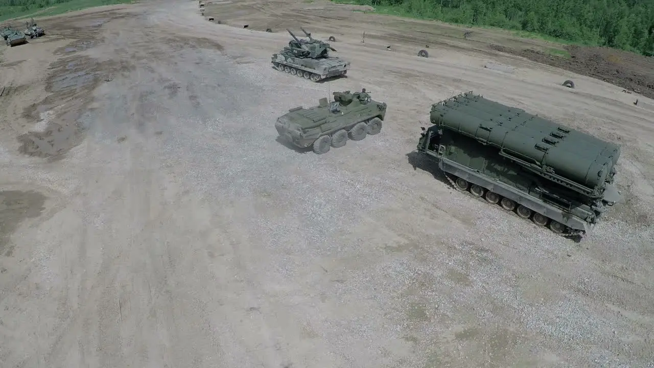 Flying over military vehicles on shooting ground