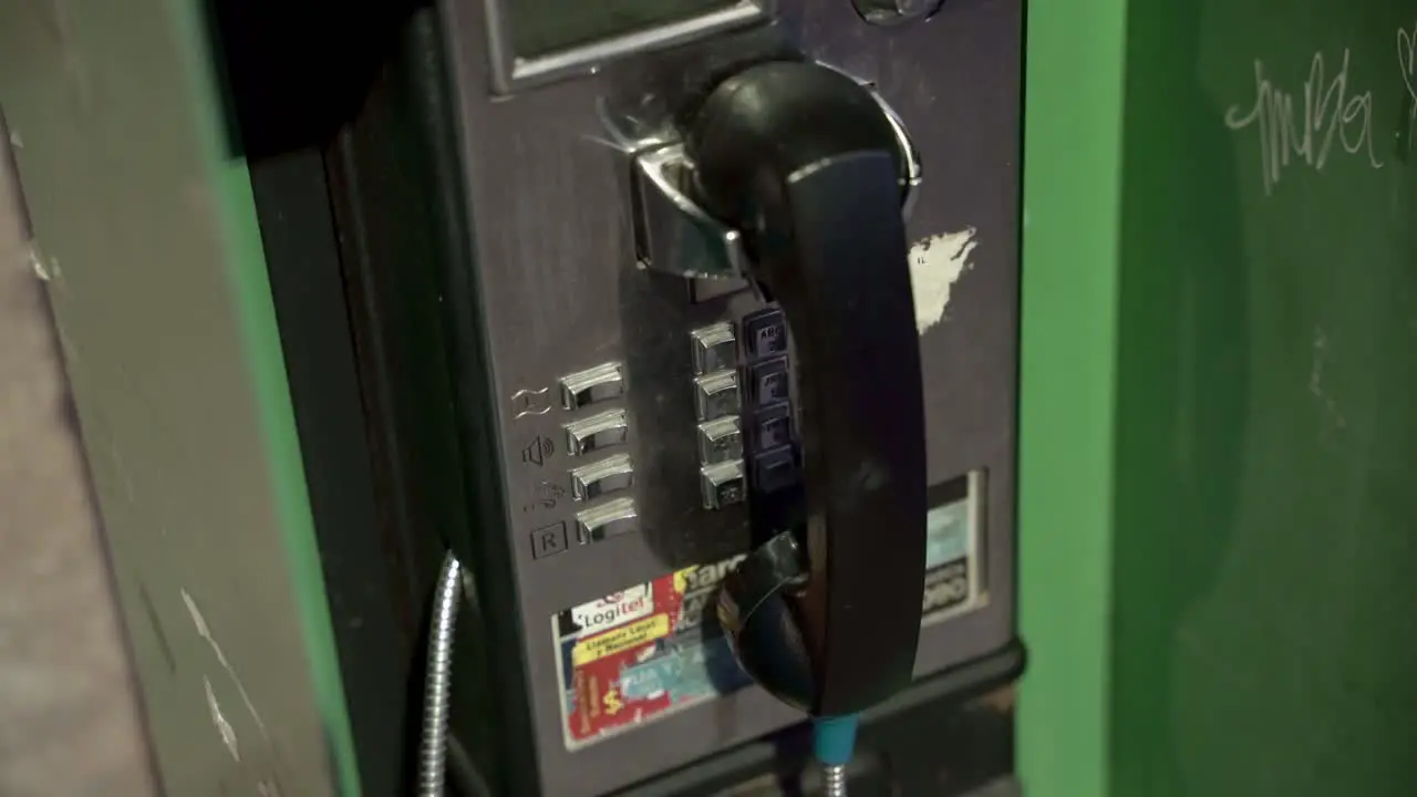 Old green payphone box in downtown